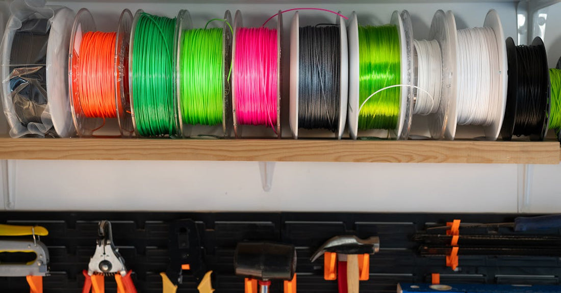 Colorful 3D printing filament spools on a workshop shelf