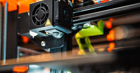 Close-up of a 3D printer nozzle in action during industrial manufacturing